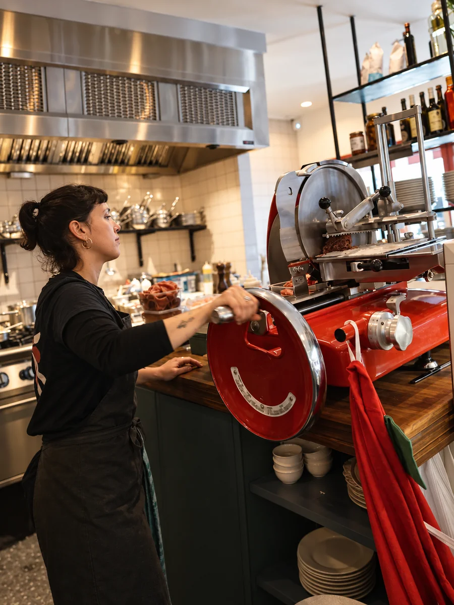 A Stassano team member working at the deli counter